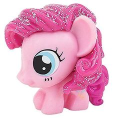 a pink pony with glitter on its head and big eyes, standing in front of a white background