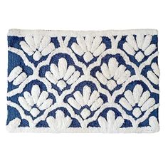 a blue and white door mat with an intricate design on the front, featuring flowers