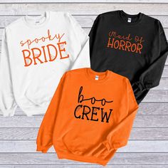 three sweatshirts with the words boo crew and spooky bride printed on them