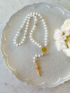 Engage with the elegant beauty of our Lily Rosary - Mary's Humility in stunning white. Delicate and prayerful, this modern Rosary embodies Mary's purity. Let your prayers be lifted to Mary as you wander through the garden of her virtue, perfect for those seeking a sophisticated touch to their spiritual practice. The centerpiece features an image of Our Lady crowned with flowers and "Ave Maria" inscribed on the back. Approx 15" 8mm glass beads in whites, with cream Our Father beads Ethically made Adjustable White Rosary For First Communion, Elegant White Rosary For First Communion, Elegant White Rosary For Wedding, Elegant White Wedding Rosary, Catholic Candles, Elegant Beauty, Catholic Gifts, Beautiful Candles, Spiritual Practices