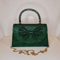 Womens dark green crystal encrusted luxury evening clutch bag with bow detail, gold embellishment, satin finish material and magnet front closing top  Can be used with or without long shoulder chain (included) size approx- H 14cm x W 22cm Free Royal Mail delivery is an estimated 3-5 days but this can occasionally be slightly longer which solely on the Royal Mail side. We do offer guaranteed next day delivery but please contact us prior to ordering as this would incur a small upgraded shipping charge. We also offer WORLDWIDE shipping - please contact us for more info 💕🌍 Glamorous Green Clutch Bag, Elegant Green Evening Bag With Rhinestones, Green Rhinestone Party Evening Bag, Glamorous Green Rectangular Clutch, Glamorous Green Event Bag, Green Rhinestone Party Bag, Elegant Green Bag For Night Out, Elegant Green Evening Bag For Events, Green Elegant Evening Bag