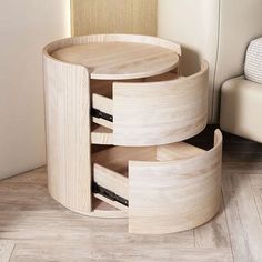 a round wooden table with two drawers on the bottom and one drawer in the middle