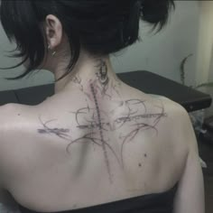 a woman with a cross tattoo on her back