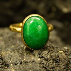 Green Nephrite Jade Ring | 24K Gold Plated | Lucky Ring Green Nephrite |925 Sterling Silver | Handcrafted Statement Ring | Gift  Our shop offer free ring sizing Handcrafted hammered  ring  Metal : 925 Sterling Silver Plating : 24K Gold Band Width : 2 mm Gem Stone : Nephrite Jade Gem Size :  15.5x11 mm Ring Weight : 4.75 grams Ring Size : US 6 (The size you want is made for free). (We used the US standard sizing)  **Custom Orders is Made** As pellada family, we will be happy to help you if you contact us with the photo and dimensions of the design you want. To return back to Pellada Shop Home Page,Click here! https://www.etsy.com/shop/Pellada Thank you for shopping! Pellada Polished Chrysoprase Ring Suitable For Gift, Handmade Green Emerald Oval Cabochon Ring, Untreated Green Emerald Ring Gift, Handmade Gold Oval Emerald Ring, Chrysoprase Emerald Ring With Oval Cabochon For Gift, Gold Emerald Ring Untreated For Gift, Nephrite Jade, Jade Ring, Gold Armband