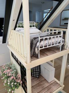 a doll house with a bed on top of it and stairs leading up to the second floor