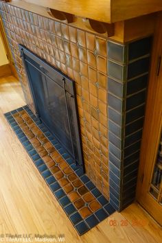 a fire place sitting inside of a kitchen next to a wooden floor and counter top