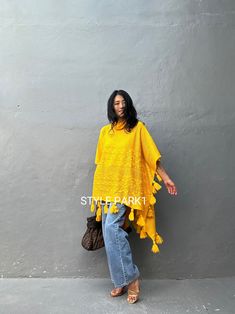 This is a warm knit poncho that is very light and stylish even if you just put on it lightly. It's a stylish product with any style such as leggings or jeans. The sleeves are open-style. ❤️Please see the professional model of Stylepark1 Her body size is medium size And Tall 174cm 5.72FT for the American size. Please look at the fit style of the model.❤️ Size - One size ( one size all fit) Width: 110cm /43.30inch Length - Back  (with tassel) 105cm /41.33inch/3.44ft Front - with tassel 70cm/27.55i One Size Poncho For Vacation In Fall, Casual Poncho For Beach Cover-up In Fall, One Size Poncho For Fall Vacation, One Size Fall Poncho For Vacation, Long Sleeve Fringe Poncho, Traditional Fringe Poncho One Size, Casual Shawl Poncho For Spring, Traditional Fringed Poncho Shawl, Oversized Fringe Cape Poncho