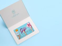 an open gift card in a box on a blue background