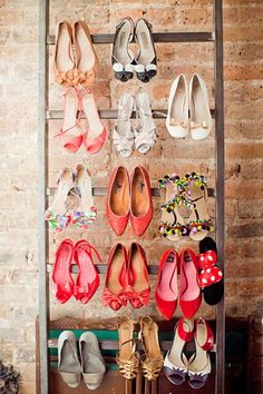 there are many pairs of shoes hanging on the wall