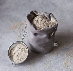 a bag filled with white powder next to a measuring spoon