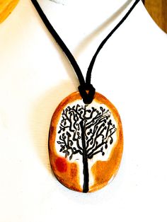 "This is a unique hand-formed and hand painted ceramic tree necklace made by Surly Amy at Surly-Ramics. This necklace has one of our small size pendants. This necklace is created using my original drawing of a tree. *PLEASE NOTE I make these in small batches so the necklace you receive may vary slightly from the one in the photo. The color, size and style will be the same but the glaze and spotting effect will settle slightly differently from piece to piece. I have posted a few photos of one of Nature-inspired Pendant Necklace With Hand Painted Details, Hand Painted Nature-inspired Pendant Necklace, Nature-inspired Hand Painted Pendant Necklace, Hand Painted Nature-inspired Necklace For Gift, Nature-inspired Hand Painted Necklace For Gift, Artisan Hand Painted White Necklace, Artisan Hand Painted White Necklaces, Artisan White Hand Painted Necklaces, Drawing Of A Tree