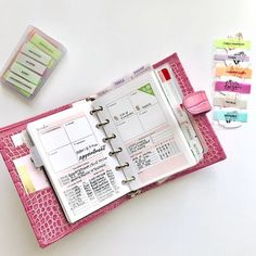 an open planner book sitting on top of a table