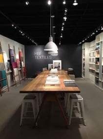 a table with chairs and books on it in a room