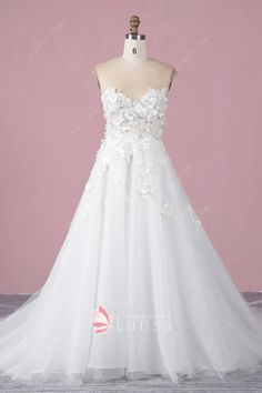 a white wedding dress with flowers on it