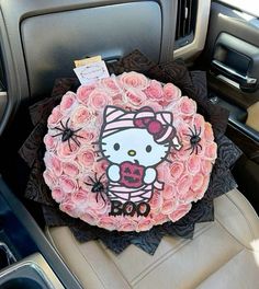 a hello kitty car decoration with pink roses