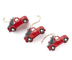 three red toy cars with christmas trees on them