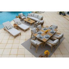 an outdoor dining set next to a swimming pool