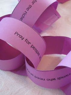 three rolls of pink paper that say pray for people and one roll has words on it