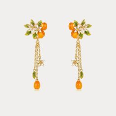 Infuse your style with a touch of nature-inspired elegance with our Golden Plum Drop Earrings, a striking accessory that captures the essence of botanical beauty. These exquisite earrings are meticulously crafted, featuring delicate plum motifs adorned with vibrant orange and green enamel. Each earring showcases a cluster of golden plums and leaves, accented by petite white blossoms that cascade down on fine golden chains. Whether you're dressing up for a special occasion or adding a unique touc Elegant Orange Flower Earrings For Gift, Elegant Orange Flower Earrings, Elegant Enamel Drop Flower Earrings, Unique Orange Drop Earrings, Whimsical Multicolor Dangle Flower Earrings, Nature-inspired Drop Flower Earrings With Charm, Golden Plum, Whimsical Multicolor Flower-shaped Earrings, Plum Flowers