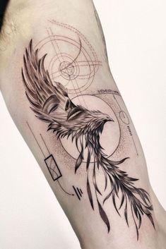 a tattoo on the arm of a man with an eagle and geometric shapes behind it