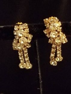 This is a Wonderful KRAMER of N.Y. vintage signed gold tone Rhinestone earrings. condition is very good vintage condition Vintage Yellow Gold Clip-on Earrings For Party, Vintage Gold Clip-on Earrings For Vintage Events, Gold Vintage Clip-on Earrings For Vintage Events, Gold Vintage Clip-on Earrings, Vintage Gold Clip-on Earrings For Party, Vintage Earrings With Sparkling Stones, Vintage Gold Clip-on Earrings With Rhinestones, Vintage Gold Crystal Earrings With Rhinestones, Gold Costume Jewelry Clip-on Earrings For Evening