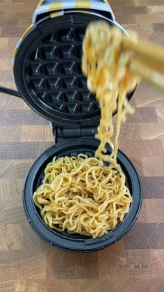 a waffle iron being used to make noodles