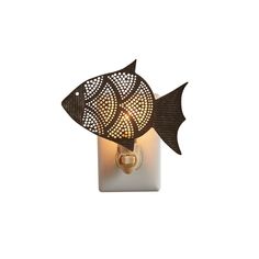 a wall light with a fish design on it's side and a candle in the middle