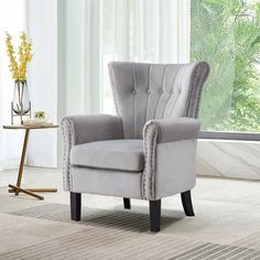 This vintage-style accent armchair combines velvet with a solid wood tufted design, seamlessly integrating into your living space. With a back width of 30 inches at its widest point and a unique wing-like silhouette, it presents a distinctive furniture style. The minimalist tufted detailing on the back and evenly spaced nailhead accents enhance the overall visual effect. The chair features a firm, wide back and a thick, independent seat cushion, offering comfortable support for chatting and rela Bedroom With Sitting Area, Velvet Accent Chair, Accent Arm Chairs, Bedroom Chair, Single Sofa, Accent Chairs For Living Room, Upholstered Sofa, Accent Chair, Upholstered Chairs