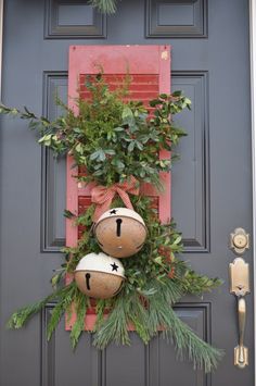 a door decorated with christmas decorations and greenery