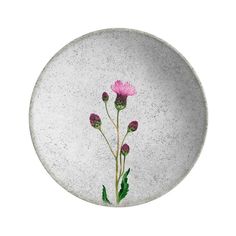 a white plate with pink flowers painted on the side and green leaves in the middle