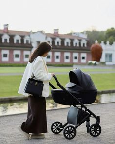 a woman is walking with her baby in a stroller