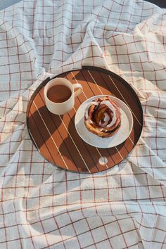 a cup of coffee sitting on top of a plate