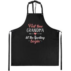 a black apron that says first time grandma let the spaking begin with pink lettering