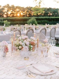 the table is set with pink and white flowers