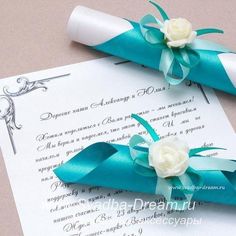 two blue and white wedding garters laying on top of an open paper document