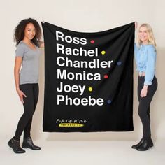 two women are holding up a black banner