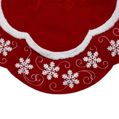 a red and white christmas hat with snowflakes on the bottom, sitting on top of a table