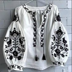 🌷Discover the elegance of our White Embroidered Peasant Blouse, a modern take on the traditional vyshyvanka. This beautifully crafted boho blouse features intricate embroidery that showcases a blend of cultural heritage and contemporary style, making it a must-have addition to your wardrobe. Designed with comfort in mind, this plus-size top offers a flattering fit for all body types. With its versatile design, this blouse can be dressed up or down, making it ideal for casual outings, festivals, or even as a stylish work piece. - Elegant white fabric with exquisite embroidery - Modern women's vyshyvanka design - Plus size options available for a perfect fit - Flowy silhouette for comfort and style - Great as a thoughtful gift for birthdays, holidays, or special occasions Embrace your uniqu White Embroidered Blouse With Bishop Sleeves, White Bishop Sleeve Tops With Floral Embroidery, White Tops With Floral Embroidery And Bishop Sleeves, Traditional White Embroidered Top For Fall, Traditional White Peasant Top For Fall, Peasant Blouse With Bishop Sleeves In White, Folk Style White Embroidered Top For Fall, Folk Style Embroidered White Top For Fall, White Peasant Top With Geometric Embroidery