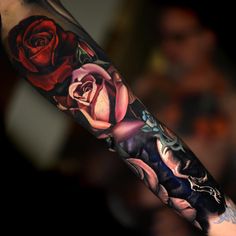 a man's arm with roses on it