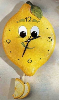 a clock made to look like a lemon with eyes and mouth on it's face