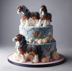 a three tiered cake decorated with horses