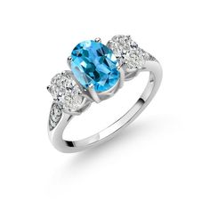 an oval blue topazte and diamond ring with three stones on the side, set in