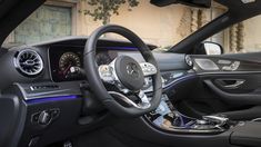 the interior of a mercedes s - class sedan with its steering wheel and dash lights