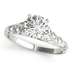 a white gold engagement ring with an intricate filigree design