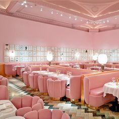 the interior of a fancy restaurant with pink booths