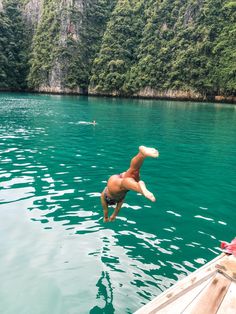 a person jumping into the water from a boat