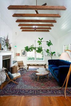 a living room filled with furniture and a rug on top of a hard wood floor