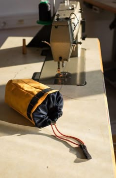 a bag sitting on top of a table next to a sewing machine