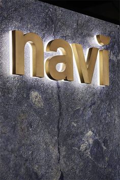 the name navi is illuminated on a stone wall