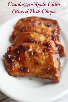 cranberry apple cider glazed pork chops on a white plate with text overlay